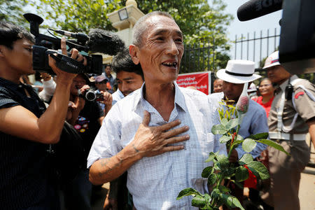 Newly released prisoners, part of over 8,000 inmates granted amnesty by Myanmar's President Win Myint to mark Myanmar's new year, walk out from Insein prison in Yangon, Myanmar April 17, 2018. REUTERS/Ann Wang