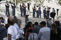 <p>Passengers wait in front a line a police officers blocking the access to Marseille ‘s main train station, Oct. 1, 2017 in Marseille, southern France. French police have warned people to avoid Marseille’s main train station following a knife attack that made at least one dead. (AP Photo/Claude Paris) </p>