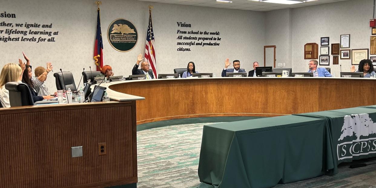 Six of the seven physically present Savannah-Chatham County Public School System board members raise their hands in approval of the district's proposed millage rate for Fiscal Year 2025 during a special session of the board on June 20, 2024.