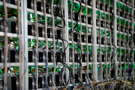 FILE PHOTO: Cryptocurrency miners are seen on racks at the HydroMiner cryptocurrency farming operation near Waidhofen an der Ybbs, Austria, April 25, 2018. REUTERS/Leonhard Foeger/File Photo