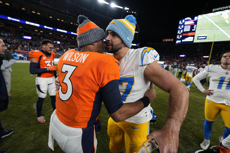 Denver Broncos quarterback Russell Wilson (3) and Los Angeles Chargers long snapper Josh Harris (47) speak midfield after an NFL football game, Sunday, Dec. 31, 2023, in Denver. The Denver Broncos won 16-9. (AP Photo/Jack Dempsey)