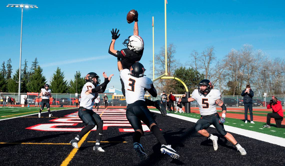 Yelm wide receiver Kyler Ronquillo elevates over Kennewick defenders Ambrose Driver (14), Aiden Garcia (3) and Ayden Metz for a fourth-down touchdown reception during Saturday afternoon’s 3A football state quarterfinal game at Yelm High School in Yelm, Washington, Nov. 19, 2022. Yelm won the game, 36-27.