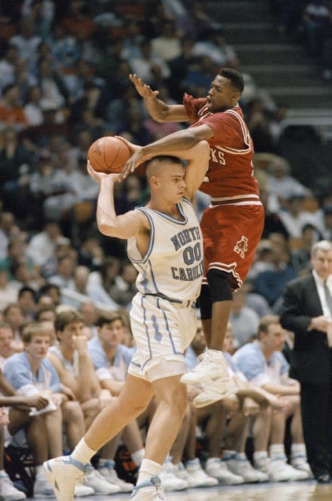 Arkansas Clint McDaniel sails over North Carolinas Eric Montross during NCAA East Regional semifinal at the Meadowlands Arena, Friday, March 27, 1993, East Rutherford, N.J. The Tarheels won 80-74, and will meet Cincinnati in Sundays regional final. (AP Photo/Bill Kostroun)