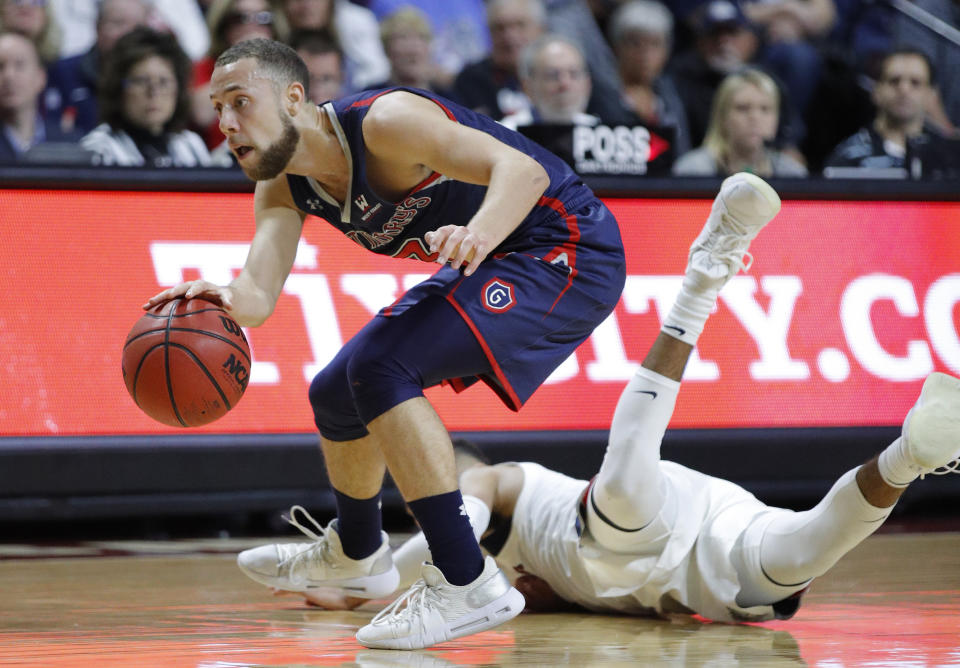 FILE - In this March 12, 2019, file photo, St. Mary's Jordan Ford dribbles around a Gonzaga player during the second half of an NCAA college basketball game in the championship pf the West Coast Conference tournament in Las Vegas. Saint Mary's certainly wasn't supposed to beat No. 1 Gonzaga last week to steal away the West Coast Conference tournament title and automatic NCAA bid. "We know that we can beat anybody," leading scorer Jordan Ford said. "Since we beat the No. 1 team in the country, and to be able to see and play against the No. 1 team in the country three times this year, we know that we can hang with anybody." (AP Photo/John Locher, File)