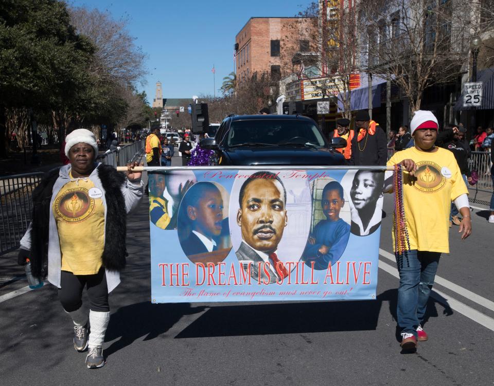 Pentecostal Temple volunteers Jadorhia Hand and Lakeresha Jackson march in the annual Martin Luther King Jr. parade in downtown Pensacola on Jan. 21, 2019.