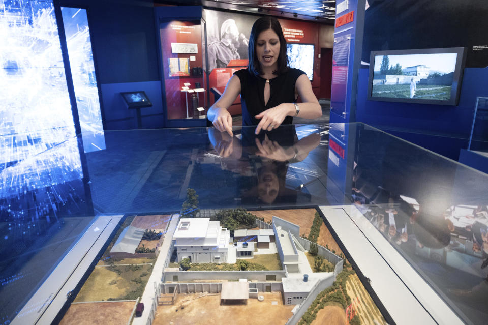 Deputy Director for the Museum in the Central Intelligence Agency Janelle Neises describes a model of the compound where U.S. forces located and killed Osama bin Laden in Abbottabad, Pakistan, that is on display in the refurbished museum in the CIA headquarters building in Langley, Va., on Saturday, Sept. 24, 2022. (AP Photo/Kevin Wolf)