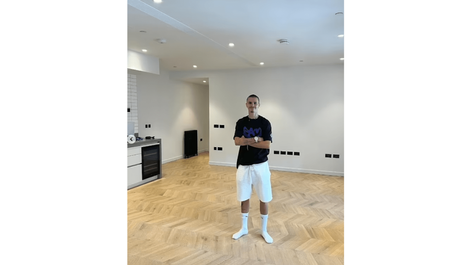 Romeo Beckham standing in an empty room