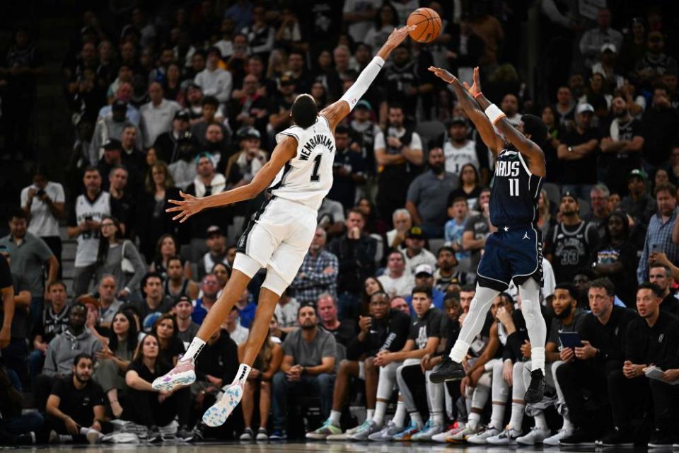 Wembanyama leaps to block a shot by the Mavericks’ Kyrie Irving in Wednesday night.