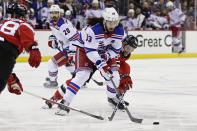 New York Rangers center Mika Zibanejad (93) battles for the puck with New Jersey Devils left wing Erik Haula during the first period of Game 7 of an NHL hockey Stanley Cup first-round playoff series Monday, May 1, 2023, in Newark, N.J. (AP Photo/Adam Hunger)