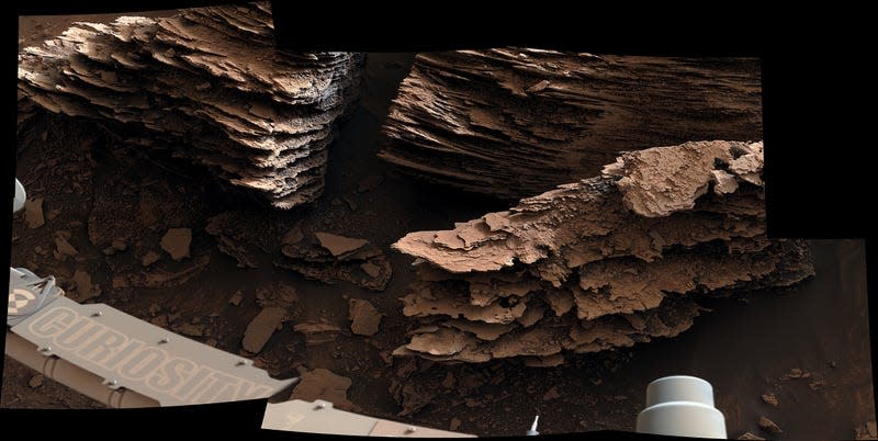 Curiosity's view of layers of flaky rocks.