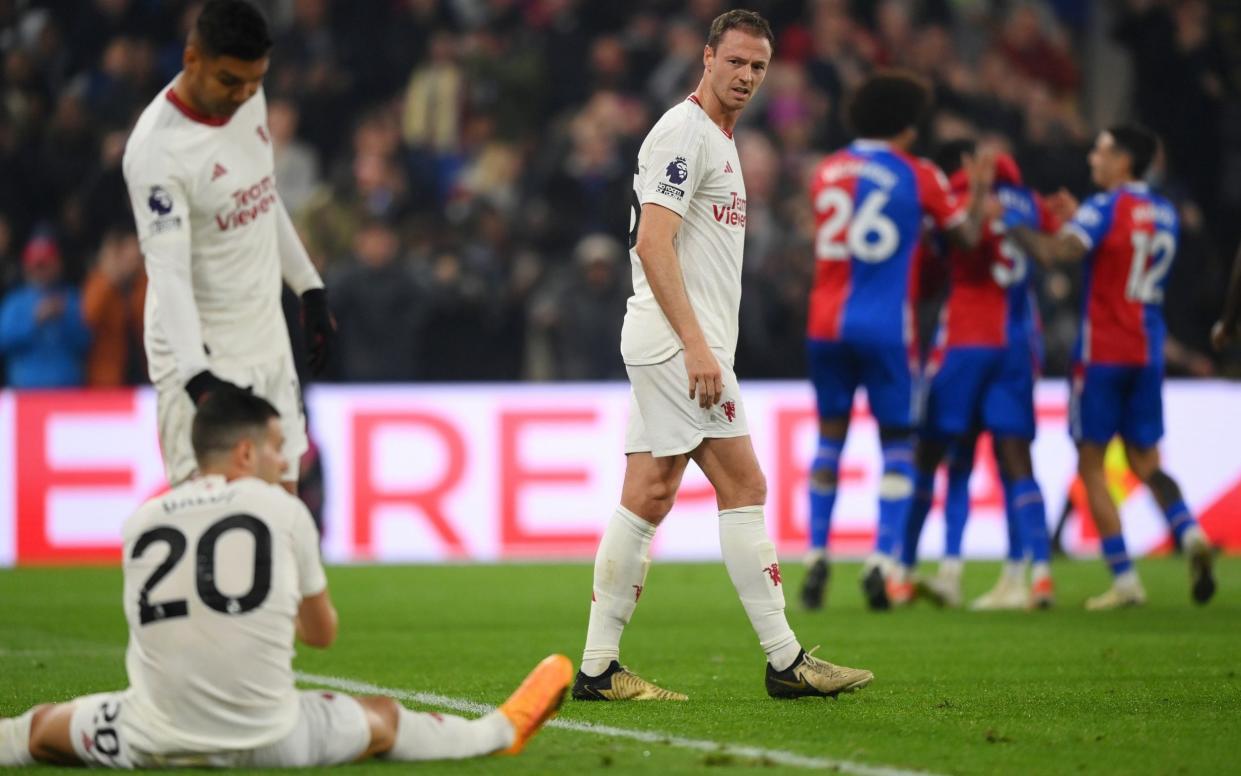 Jonny Evans of Manchester United looks dejected as he looks back towards Casemiro and Diogo Dalot after Tyrick Mitchell