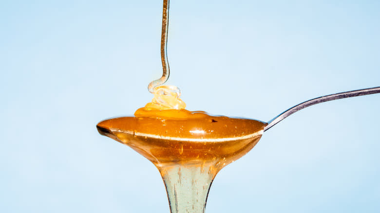 honey drizzled onto a spoon