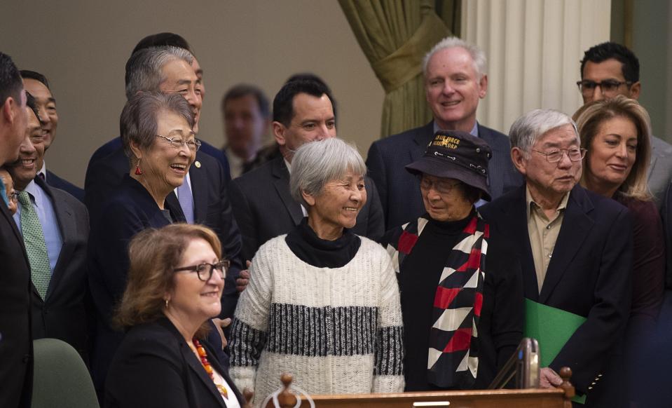 Assemblyman Al Muratsuchi, D-Torrance, in back, joins Japanese Americans who were incarcerated during World War II after the California Assembly passed House Resolution 77 on Thursday, Feb. 20, 2020, in Sacramento. Muratsuchi is the author of the resolution, which apologizes for the state's role in supporting the internment and its failure to protect the civil rights of citizens of Japanese ancestry. HR 77 passed one day after the anniversary of the signing of Executive Order 9066, which authorized the incarceration, by President Franklin D. Roosevelt in 1942. (Paul Kitagaki Jr./The Sacramento Bee via AP).