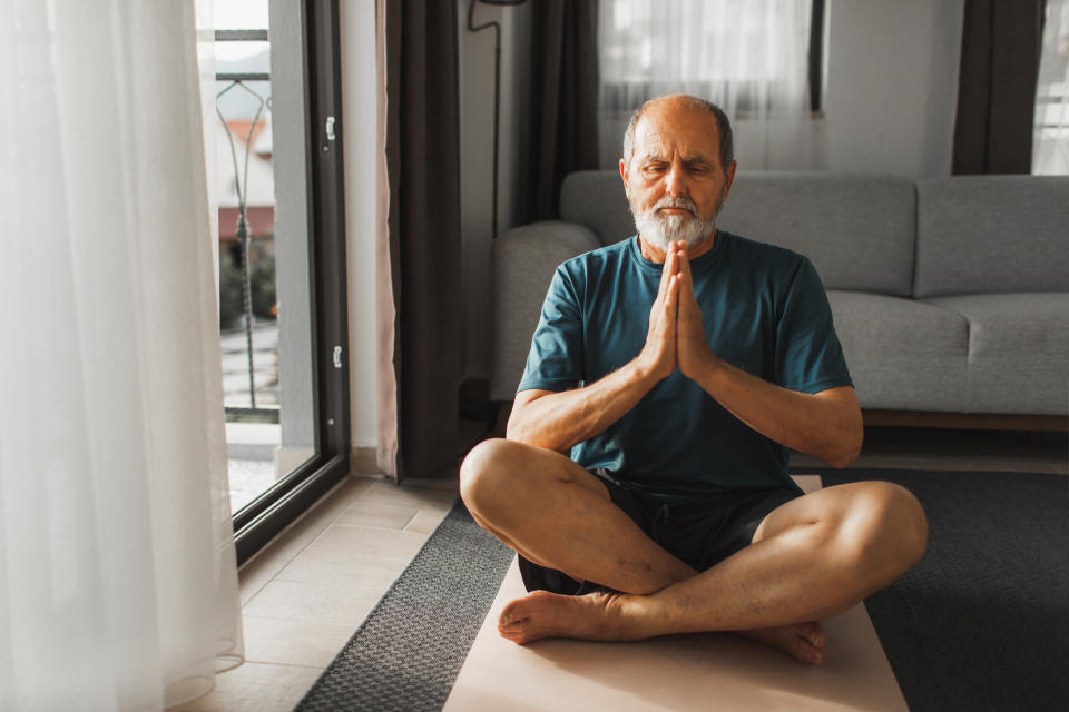 Life balance and energy in old age. Senior man doing relaxation exersize. Physical activity for mental health. Wellbeing and health.