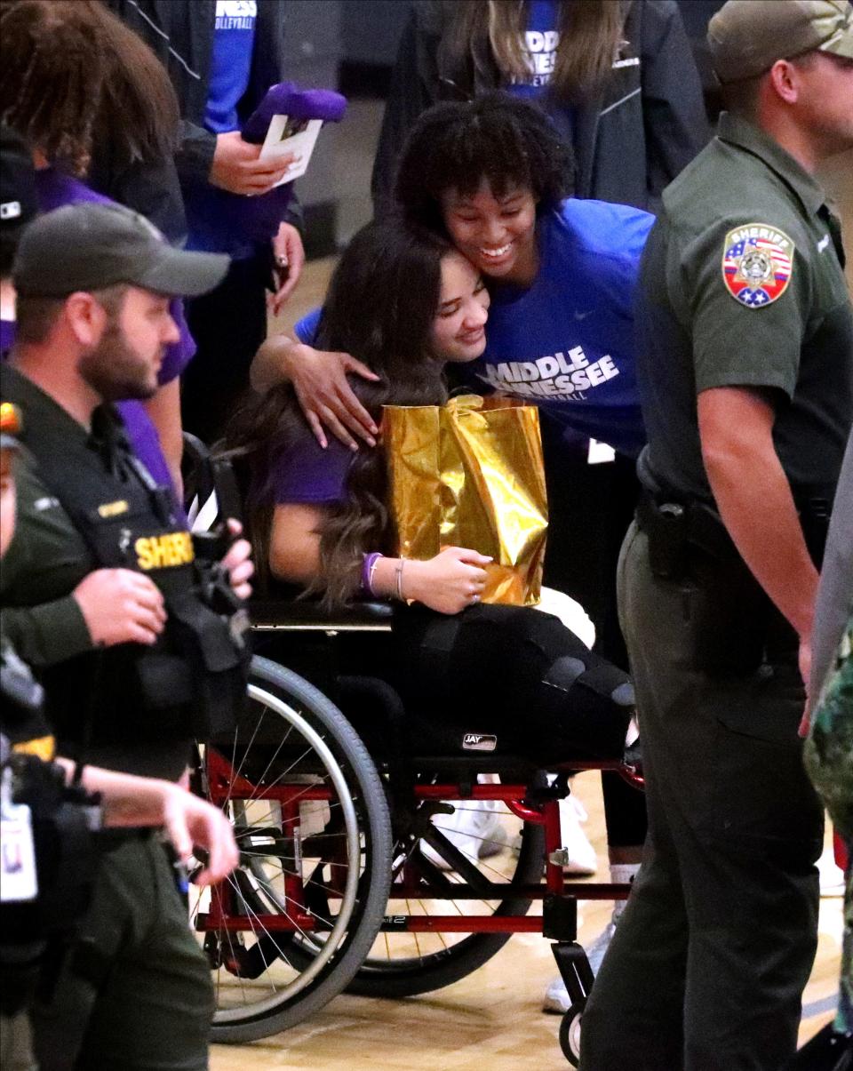 Smyrna volleyball and basketball player Janae Edmondson gets a hug from an MTSU volleyball player after the "Light up the Night" event was held for Edmondson on Wednesday, April 5, 2023, at Smyrna High School, just over a month after Edmondson lost her legs in an accident in St. Louis.