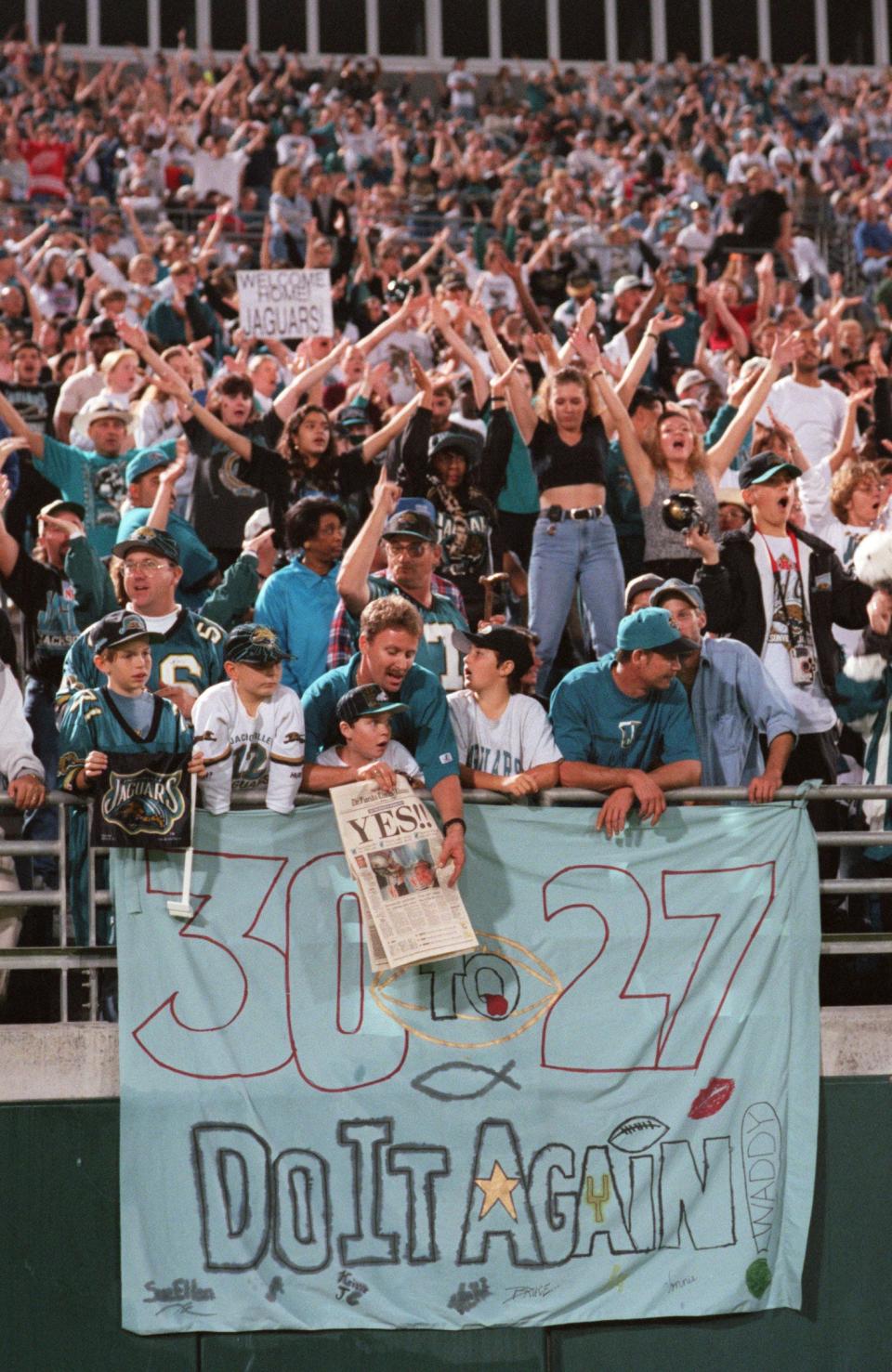 Jaguars fans cheer as they wait for the team to arrive at Jacksonville Municipal Stadium early Jan. 5, 1997, after the team beat the Denver Broncos in the playoffs.