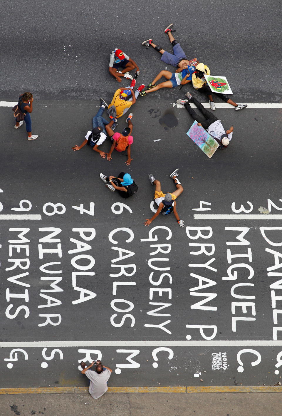 Protesters take a rest on June 26 next to the names of victims of the ongoing unrest.