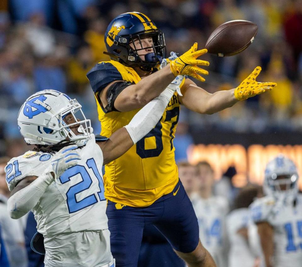 North Carolina’s Kaleb Cost (21) defends West Virginia’s Will Dixon (87) in the fourth quarter during the Duke’s Mayo Bowl on Wednesday, December 27, 2023 at Bank of American Stadium in Charlotte, N.C.