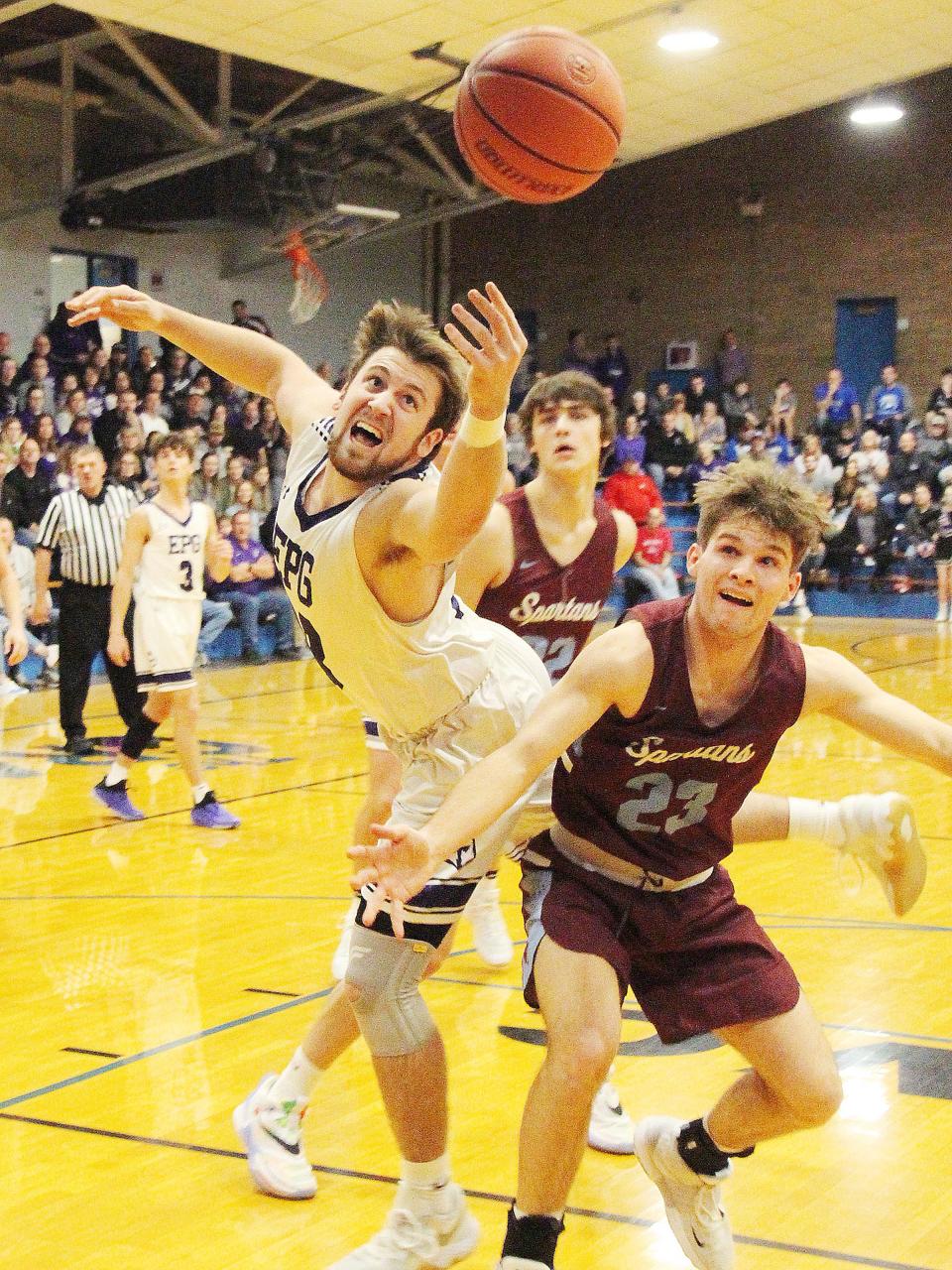 Ben Klein of El Paso-Gridley lunges for the ball on a rebound attempt against Evan Ingram of St. Joseph-Ogden Wednesday. Klein had 6 rebounds in the Titans' 54-32 victory at the Clifton Sectional.