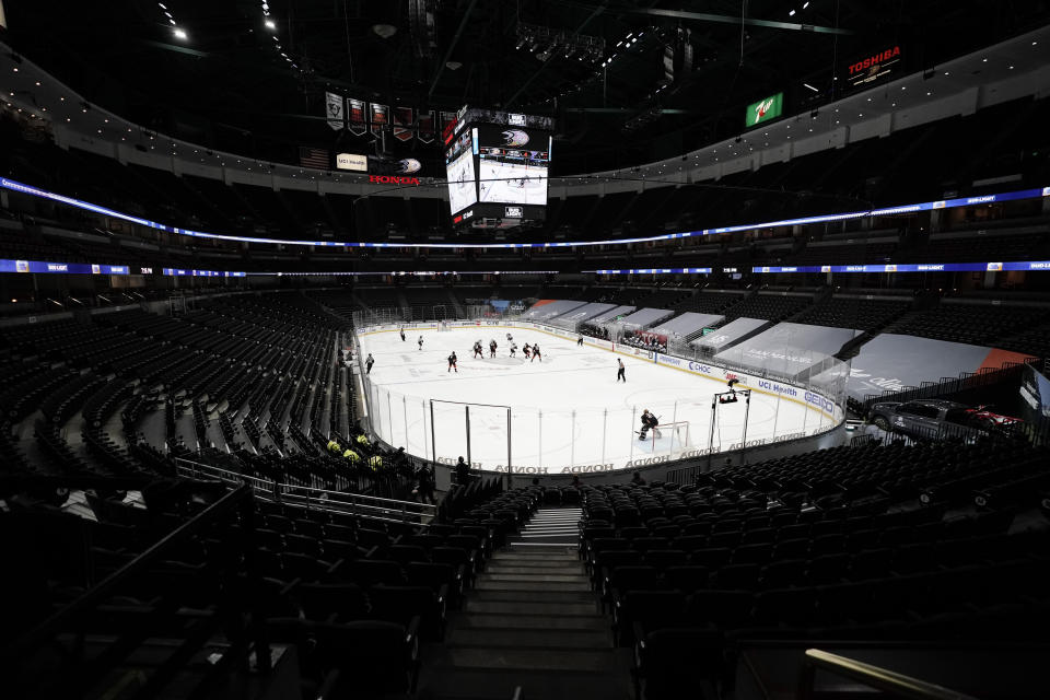 The Anaheim Ducks play the St. Louis Blues in an empty arena due to COVID-19 restrictions during the second period of an NHL hockey game Saturday, Jan. 30, 2021, in Anaheim, Calif. (AP Photo/Jae C. Hong)