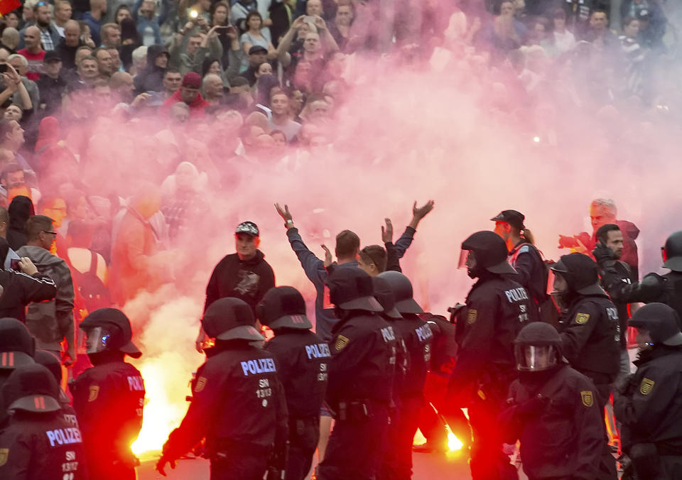 <p>Protesters light fireworks during a far-right demonstration in Chemnitz, Germany, Monday, Aug. 27, 2018 after a man has died and two others were injured in an altercation between several people of “various nationalities” in the eastern German city of Chemnitz on Sunday. (Photo: Jens Meyer/AP) </p>