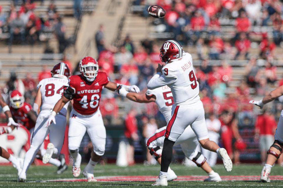 Oct 22, 2022; Piscataway, New Jersey, USA; Indiana Hoosiers quarterback Connor Bazelak (9) throws the ball as Rutgers Scarlet Knights defensive lineman Kyonte Hamilton (48) pursues during the first half at SHI Stadium.