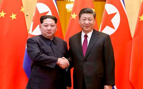 North Korean leader Kim Jong-un and Chinese President Xi Jinping pose for a photo in Beijing in March - Credit: AP