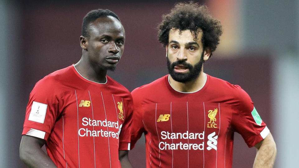 Liverpool's Sadio Mane (L) speaks with midfielder Mohamed Salah during a match.