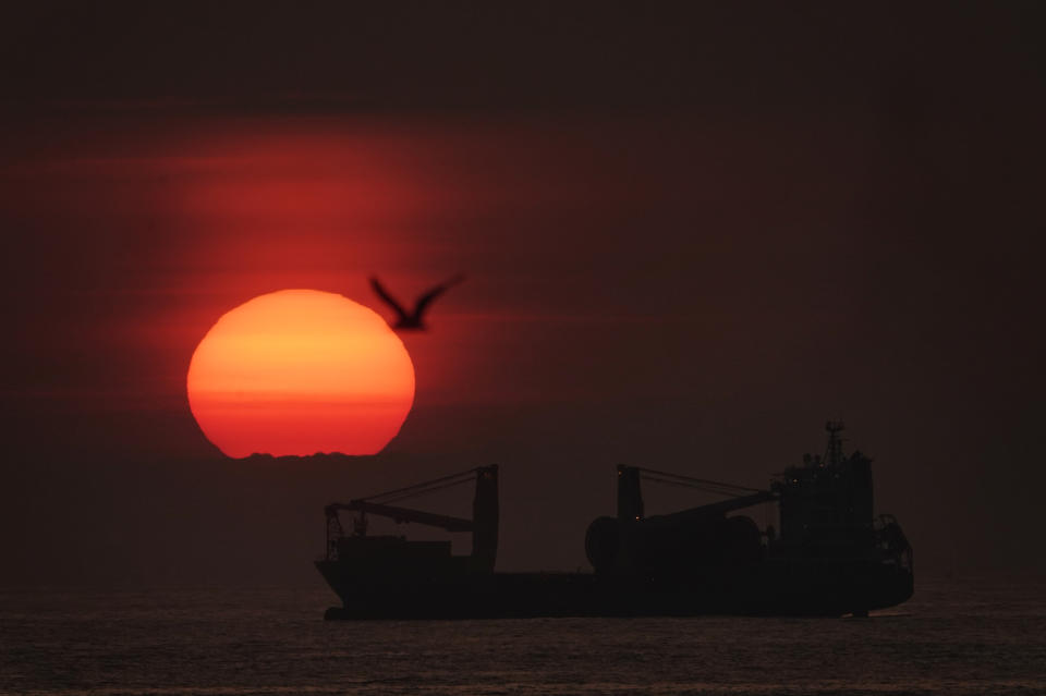 The sun rises through the mist over a BBC Fuji Cargo Ship anchored just of the north east coast at Tynemouth. Picture date: Tuesday July 16, 2019. A partial lunar eclipse is set to be visible across parts of the UK on Tuesday, if clear weather and conditions hold up. See PA story WEATHER Sunrise. Photo credit should read: Owen Humphreys/PA Wire (Photo by Owen Humphreys/PA Images via Getty Images)