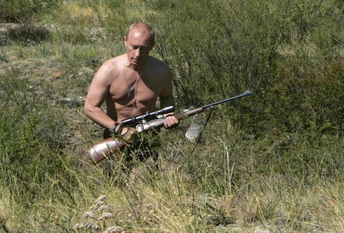 Russian Prime Minister Vladimir Putin carries a hunting rifle during his trip in Ubsunur Hollow in the Siberian Tyva region (also referred to as Tuva), on the border with Mongolia, Russia in Sept. 2010. (Dmitry Astakhov, Sputnik, Kremlin Pool Photo via AP)