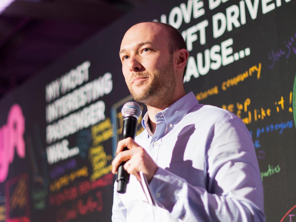 Logan Green, Lyft cofounder and CEO, speaking into microphone