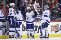 Tampa Bay Lightning left wing Pierre-Edouard Bellemare (41) celebrates with Andrei Vasilevskiy (88) after defeating the New Jersey Devils in an NHL hockey game Tuesday, March 14, 2023, in Newark, N.J. The Lightning won 4-1. (AP Photo/Adam Hunger)