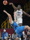 France's Moustapha Fall (93) blocks Slovenia's Luka Doncic (77) during a men's basketball semifinal round game at the 2020 Summer Olympics, Thursday, Aug. 5, 2021, in Saitama, Japan. (AP Photo/Eric Gay)