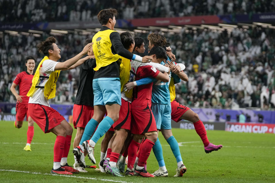 South Korea's players celebrate after the winning penalty in a penalty shootout at the end of the Asian Cup Round of 16 soccer match between Saudi Arabia and South Korea, at the Education City Stadium in Al Rayyan, Qatar, Tuesday, Jan. 30, 2024. (AP Photo/Thanassis Stavrakis)