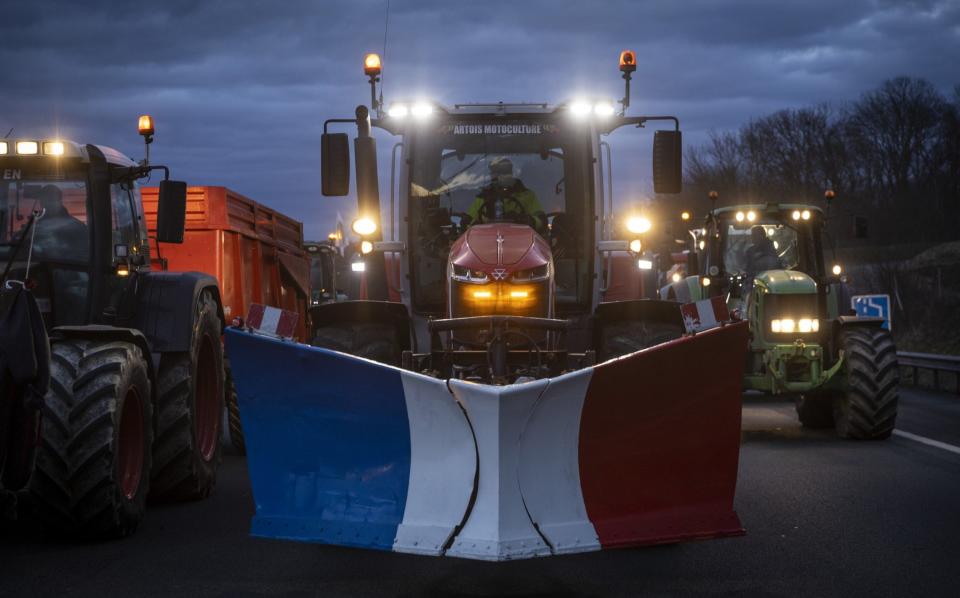 A convoy of tractors head for the Charles de Gaulle Airport as they attempt to blockade Paris, Jan 30