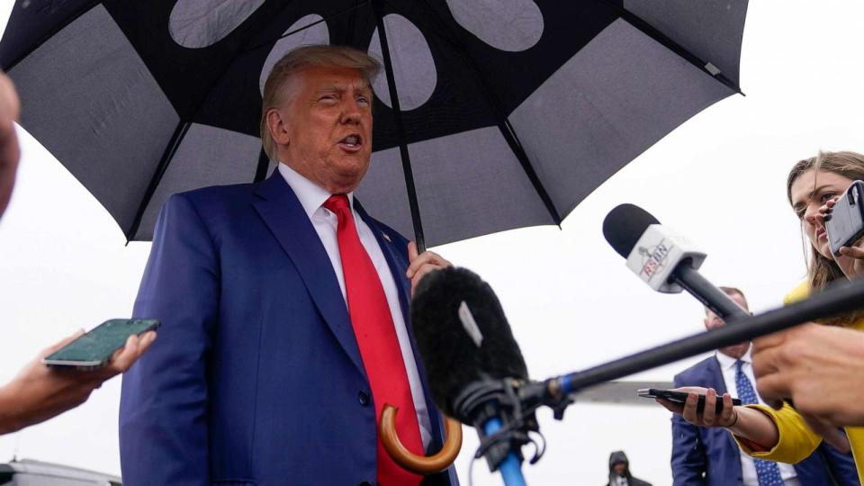 PHOTO: Former President Donald Trump speaks before he boards his plane at Ronald Reagan Washington National Airport, Aug. 3, 2023, in Arlington, Va., after facing a judge on federal conspiracy charges that allege he conspired to subvert the 2020 election. (Alex Brandon/AP)