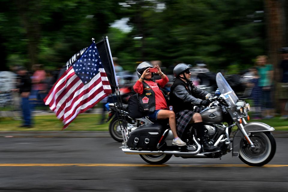 <p>A passenger on a motorcycle takes a photo as they and thousands of others made their way on Constitution Ave. today. Thousands of motorcyclists swarmed the Washington, D.C. area today to take part for the 30th annual Rolling Thunder Memorial Day event. (Photo: Michael S. Williamson/The Washington Post via Getty Images) </p>