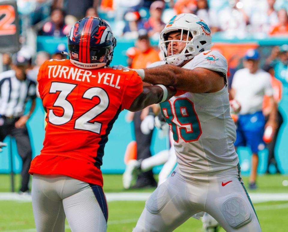 Miami Dolphins tight end Julian Hill (89) blocks Denver Broncos safety Delarrin Turner-Yell (32) during fourth quarter of an NFL football game at Hard Rock Stadium on Sunday, Sept. 24, 2023 in Miami Gardens, Fl.
