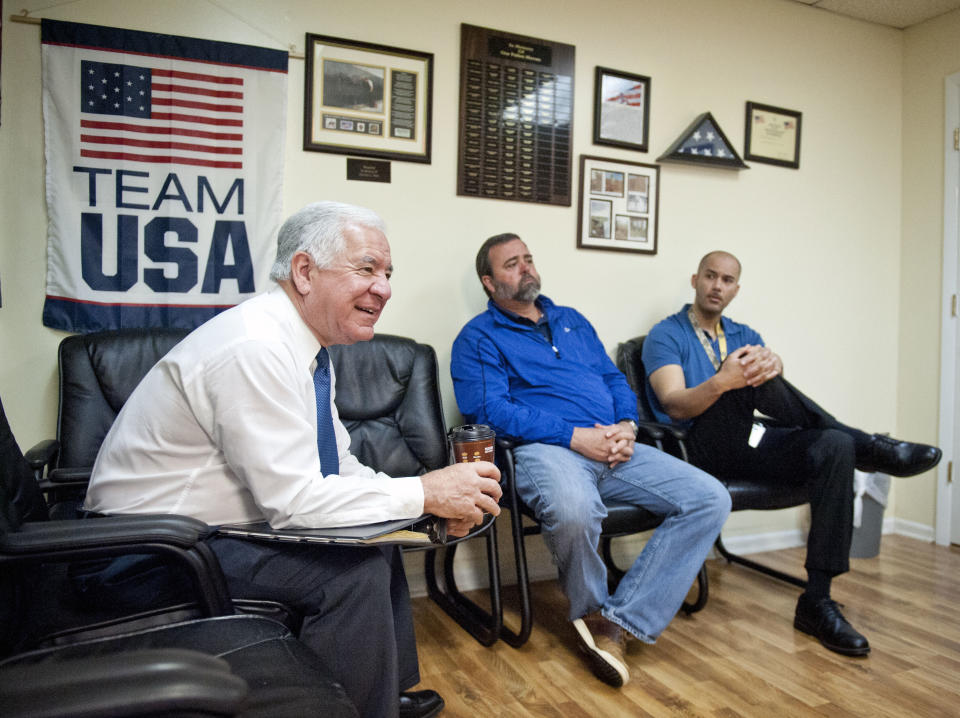 U.S. Rep. Nick Rahall , left, speaks with staff members at the Princeton Veterans Center in Princeton, W.Va., Monday, April 21, 2014. In a state where Republicans are breaking losing streaks that predate the Eisenhower administration, Rahall, a nearly 40-year Democratic House incumbent, is one of the GOP’s top targets. (AP Photo/Michael Shroyer)