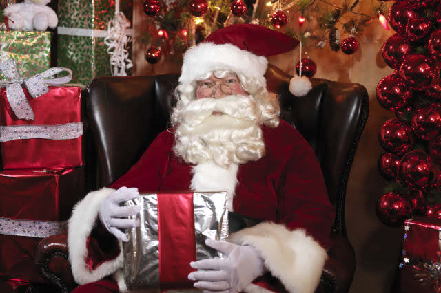 Father Christmas surrounded by presents