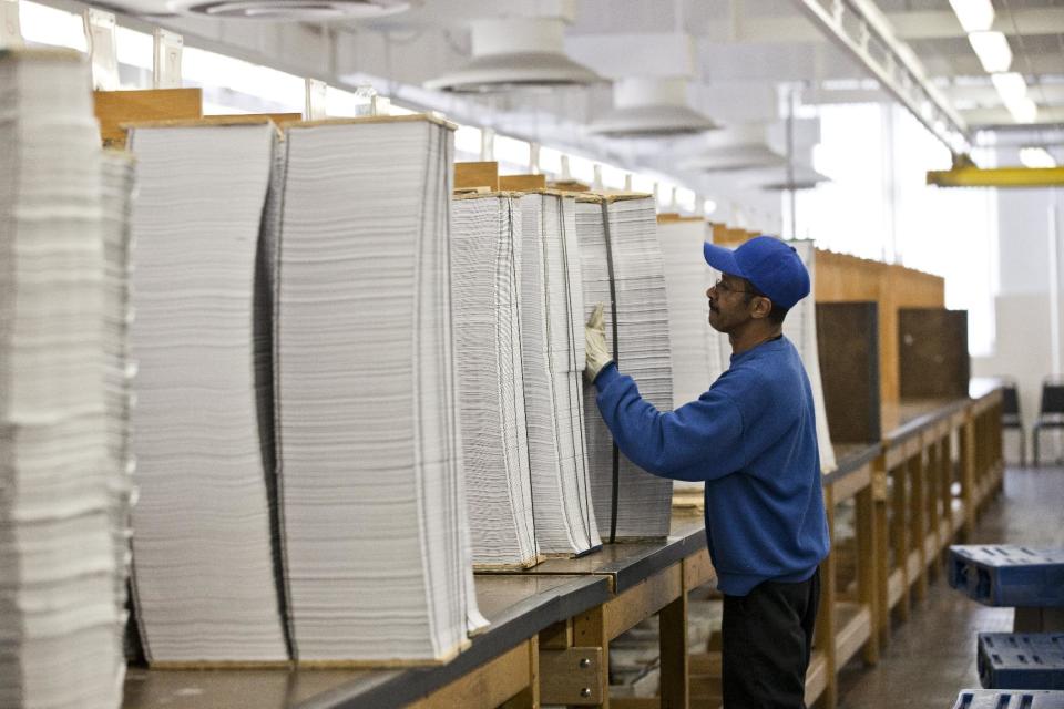 FILE - In this April 8, 2013, file photo, printed copies of President Barack Obama's proposed budget plan for fiscal year 2014 are prepared for binding at the U.S. Government Printing Office in Washington, Monday, April 8, 2013. Six years into his presidency, Obama is unveiling a budget on Tuesday, March 4, 2014, for fiscal year 2015 that for once does not herald a partisan legislative showdown. There's no push to overhaul health care as he did in 2009, no drive as in 2010 to restrict Wall Street, or to increase taxes as in 2011 and 2012, or to halt automatic spending cuts as in 2013. (AP Photo/J. Scott Applewhite)