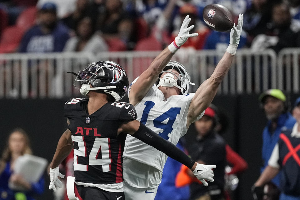 Indianapolis Colts wide receiver Alec Pierce (14) misses the catch against Atlanta Falcons cornerback A.J. Terrell (24) during the second half of an NFL football game, Sunday, Dec. 24, 2023, in Atlanta. (AP Photo/John Bazemore)