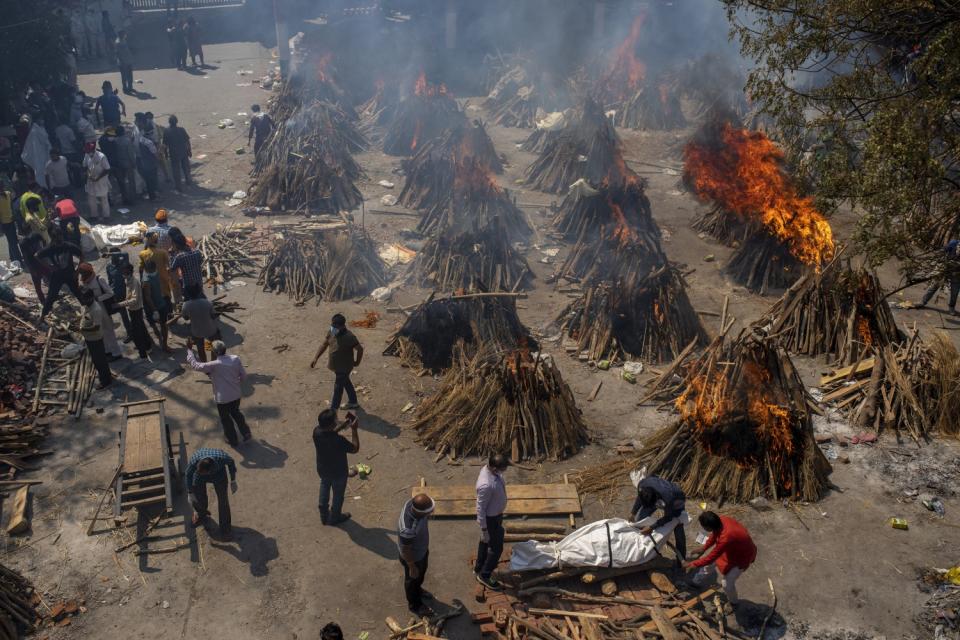 Flames and smoke rise from numerous funeral pyres