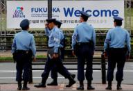 Police officers stand guard in front of the venue for G20 Finance Ministers and Central Bank Governors Meeting in Fukuoka
