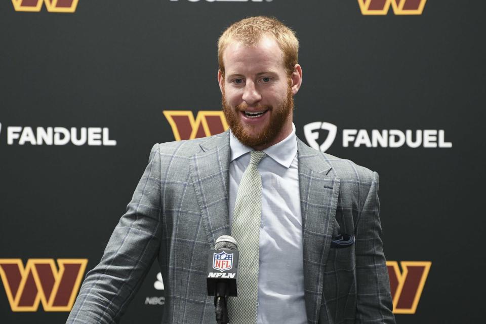 Washington Commanders head coach Ron Rivera quarterback Carson Wentz talks with the media after an NFL football game against the Detroit Lions in Detroit, Sunday, Sept. 18, 2022. (AP Photo/Lon Horwedel)