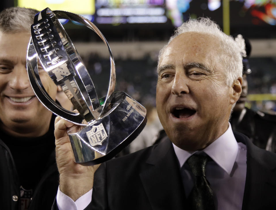 Philadelphia Eagles owner Jeffrey Lurie holds the George Halas Trophy after the NFL football NFC championship game against the Minnesota Vikings. (AP)