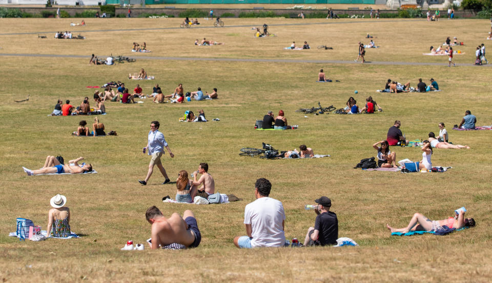 People enjoying the good weather in Greenwich Park, south London, as the public are being reminded to practice social distancing following the relaxation of lockdown restrictions.