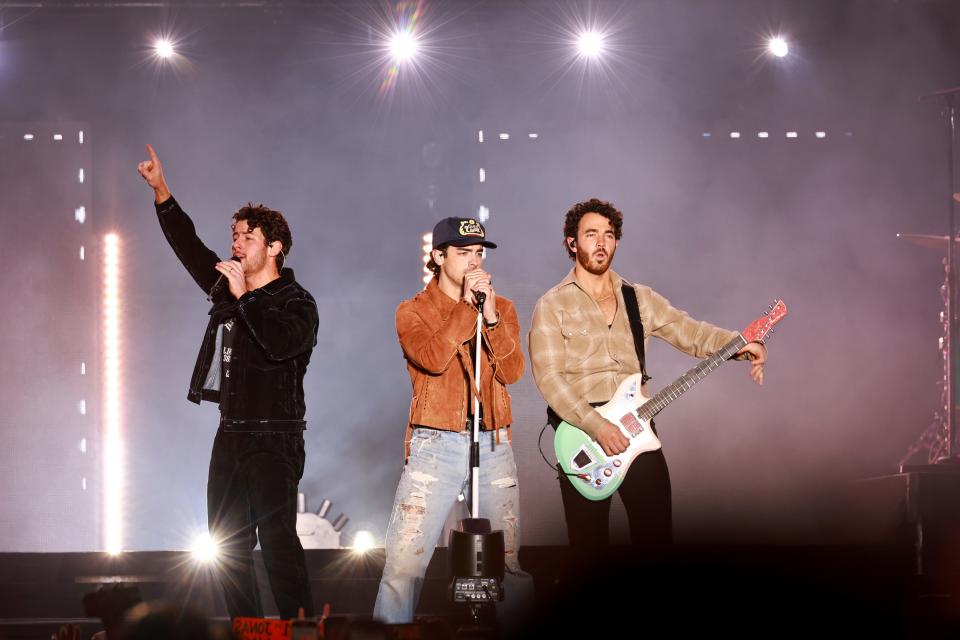 Nick Jonas (left to right), Joe Jonas and Kevin Jonas perform during the AT&T Playoff Playlist Live at Banc of California Stadium on Jan. 7 in Los Angeles.