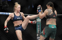 Holly Holm kicks Raquel Pennington during a UFC 246 women's bantamweight mixed martial arts bout Saturday, Jan. 18, 2020, in Las Vegas. (AP Photo/John Locher)