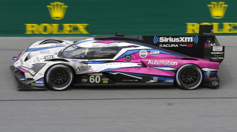 FILE - Simon Pagenaud, of France, drives the Acura ARX-06 through the front stretch during the Rolex 24 hour auto race at Daytona International Speedway, Sunday, Jan. 29, 2023, in Daytona Beach, Fla. Simon Pagenaud won back-to-back Rolex watches driving for a team that isn't at Daytona International Speedway to defend its two titles in the prestigious endurance race. But Pagenaud could not have driven anyway: the Frenchman is still recovering from injuries suffered in a July crash during IndyCar practice. (AP Photo/John Raoux, File)